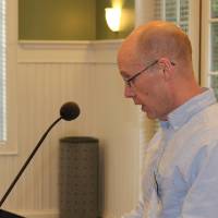 Presenter looking at notes